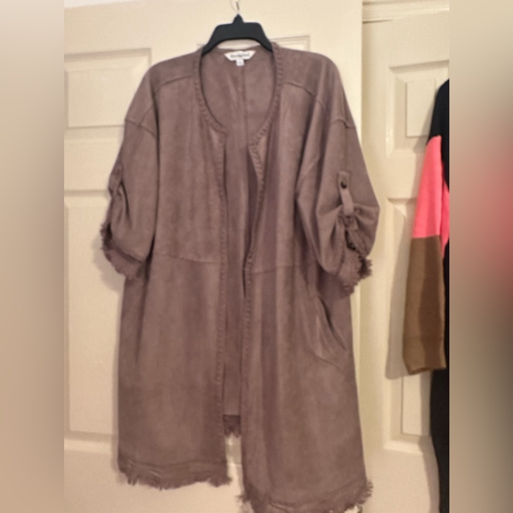 Tan brushed material like light suede looking material. NWT sz large